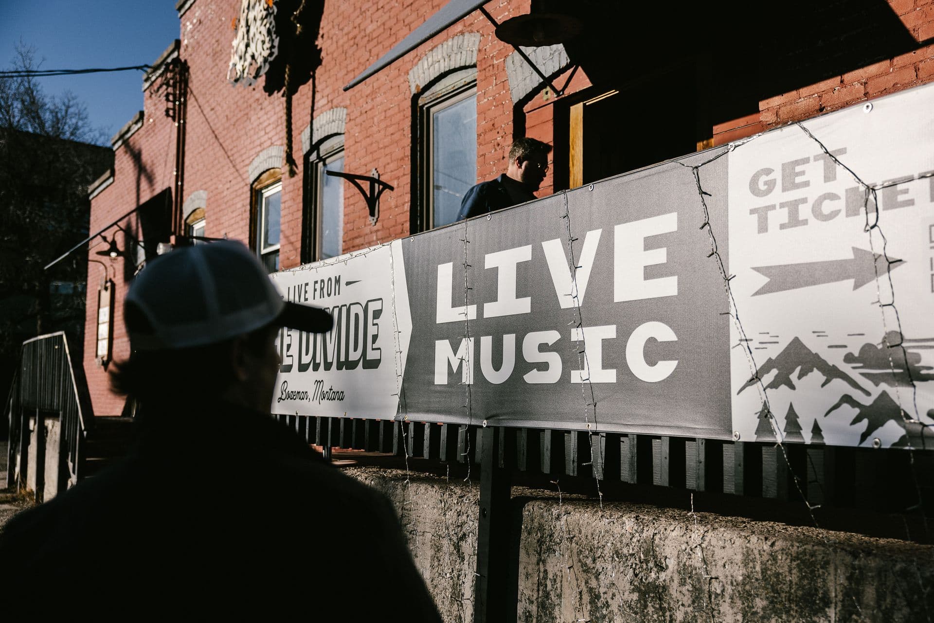Live music banner on brick building exterior, Green Door venue.